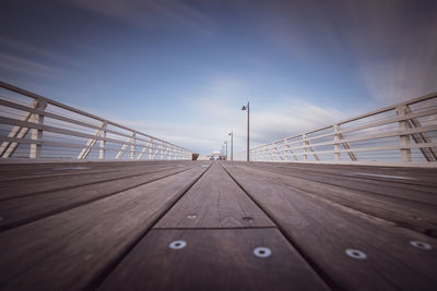 Surface level of wooden pier against sky