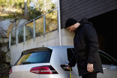 Man charging electric car