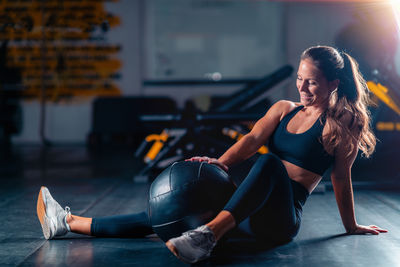 Side view of woman exercising in gym