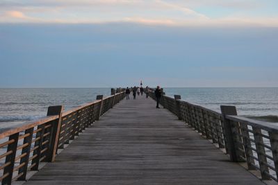 Jetty on sea against sky