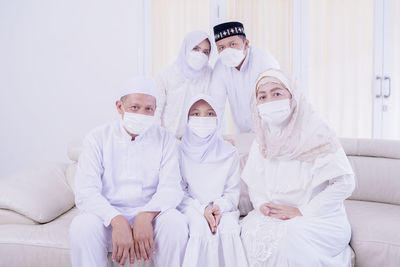 Full length of father with daughter sitting on floor