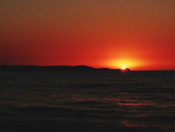 Scenic view of sea against romantic sky at sunset