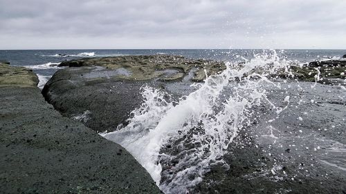 Scenic view of sea against cloudy sky