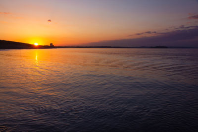 Scenic view of sea against romantic sky at sunset