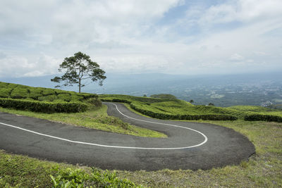 Scenic view of road by landscape against sky