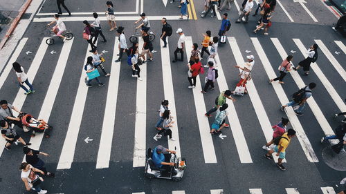 High angle view of people walking on zebra crossing