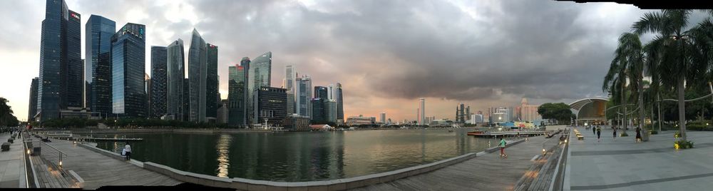 Panoramic view of city against cloudy sky