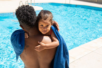 Portrait of young woman swimming in pool