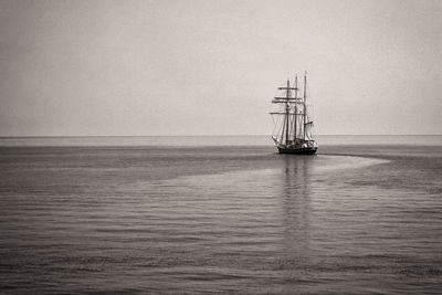 Sailboat sailing on sea against sky