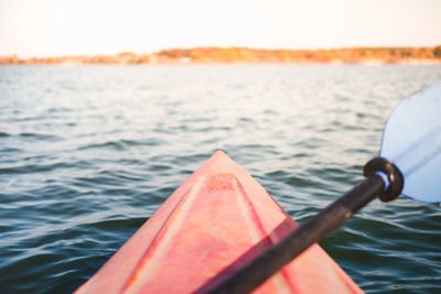 Close-up of boat in sea against clear sky