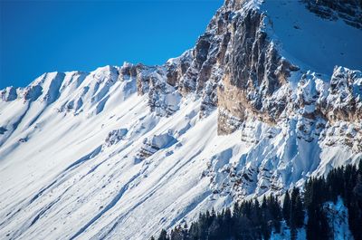 Scenic view of snowcapped mountains against clear blue sky