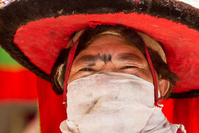 Close-up portrait of man wearing red hat