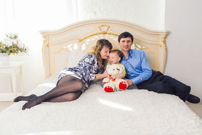 Full length of couple sitting at home