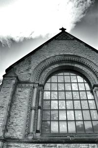 Low angle view of building against cloudy sky