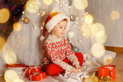 Boy sitting on floor during christmas