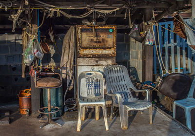 Empty chairs at abandoned gas station