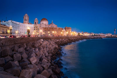 Illuminated buildings against blue sky