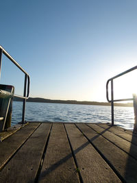 Pier on sea against clear sky