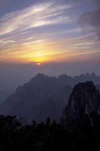 Scenic view of mountains against sky during sunset