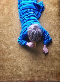 High angle view of boy relaxing on floor