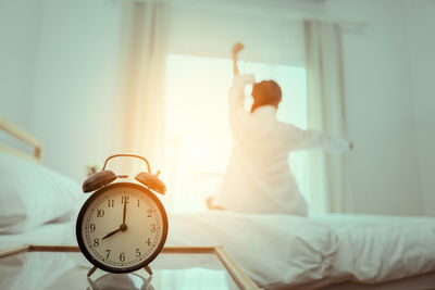 Close-up of woman hand on bed at home