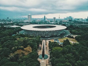 High angle view of buildings against cloudy sky