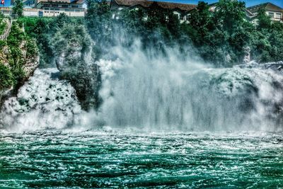 Scenic view of waterfall in sea