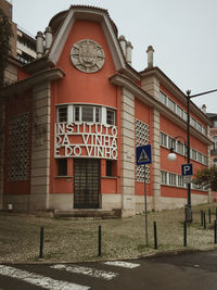 View of road sign against buildings in city