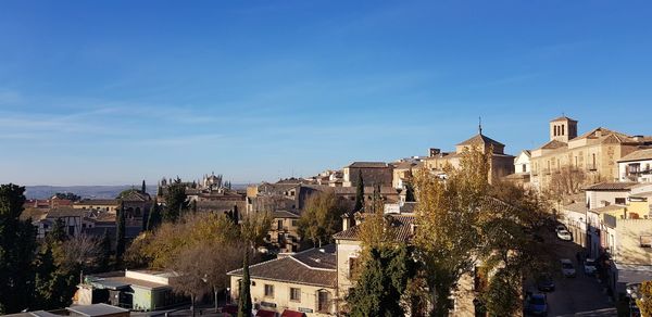 Buildings in city against blue sky