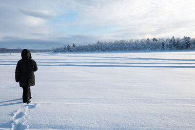 Full length of man on snow field against sky