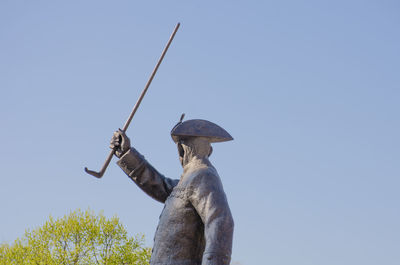 Low angle view of statue against clear blue sky