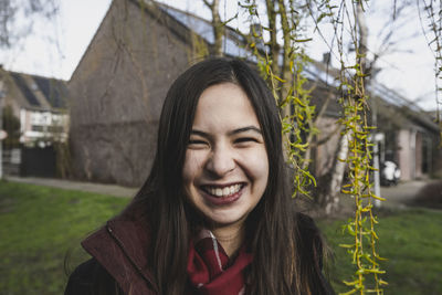 Young smiling woman is on the walk in spring day, outdoor view.