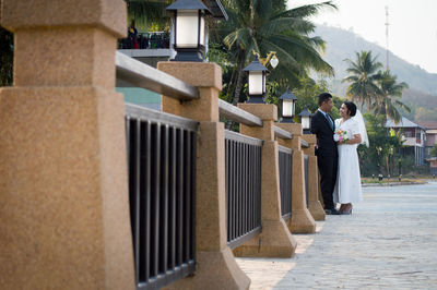 Rear view of couple standing outside building