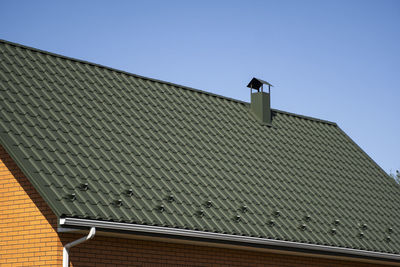 Low angle view of roof of building against clear sky