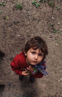 Portrait of cute girl holding flower