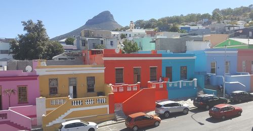 Buildings in city against sky on sunny day