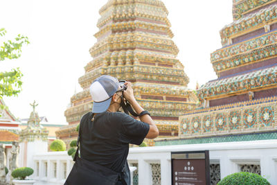 Side view of woman drinking water in temple