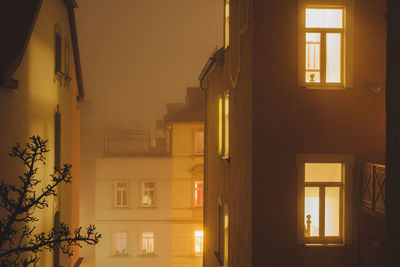 Buildings against sky at night