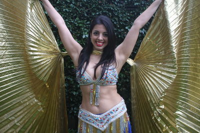 Portrait of a beautiful belly dancer with isis golden wing