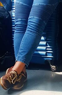 Low section of woman standing on tiled floor