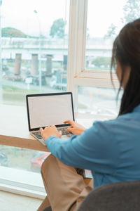 Businesswoman using laptop at office