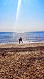 Man on beach against clear sky