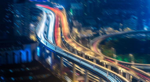 Light trails on road in city at night