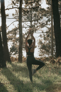 Rear view of woman standing in park