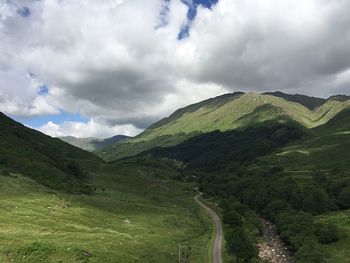 Scenic view of mountains against cloudy sky