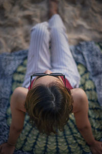 High angle view of woman sitting on beach