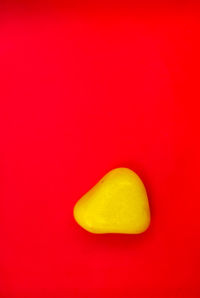 Close-up of yellow fruit against red background