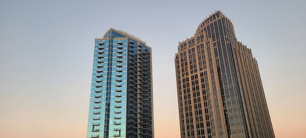 Low angle view of skyscrapers against clear sky