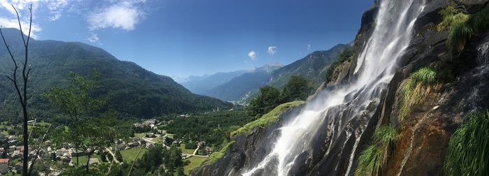 Scenic view of waterfall against sky