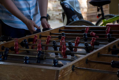 Midsection of man playing foosball